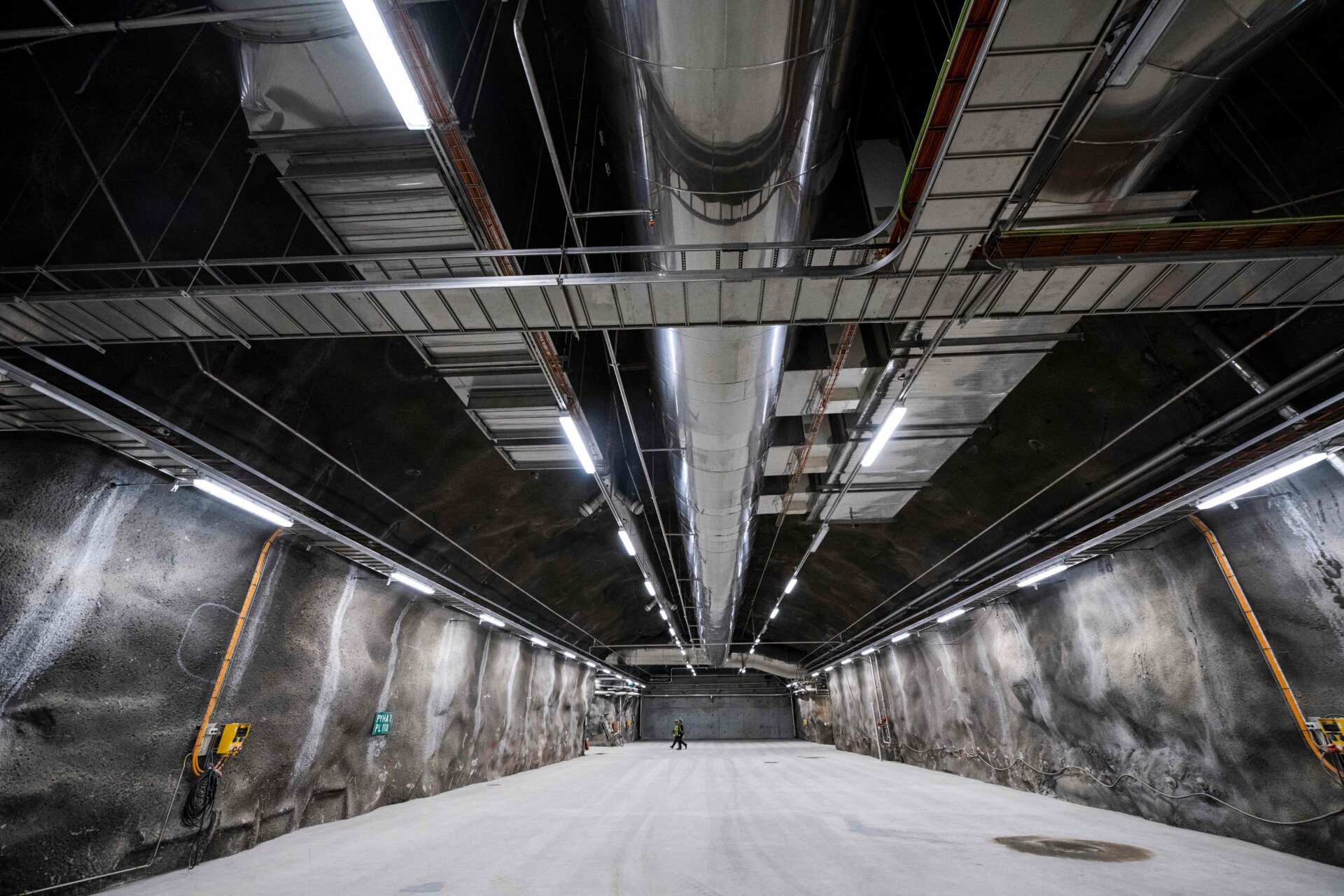 Workers walk in the Repository in Onkalo, a deep geological disposal underground facility, designed to safely store nuclear waste, on May 2, 2023, on the island of Eurajoki, western Finland.